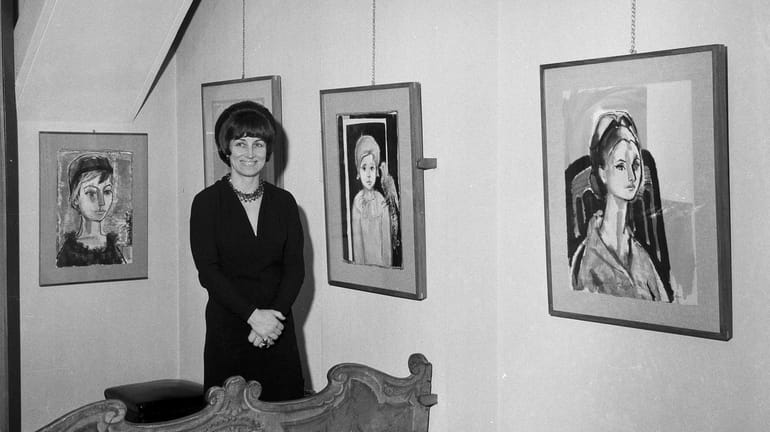 Artist Francois Gilot poses with her work at a personal...