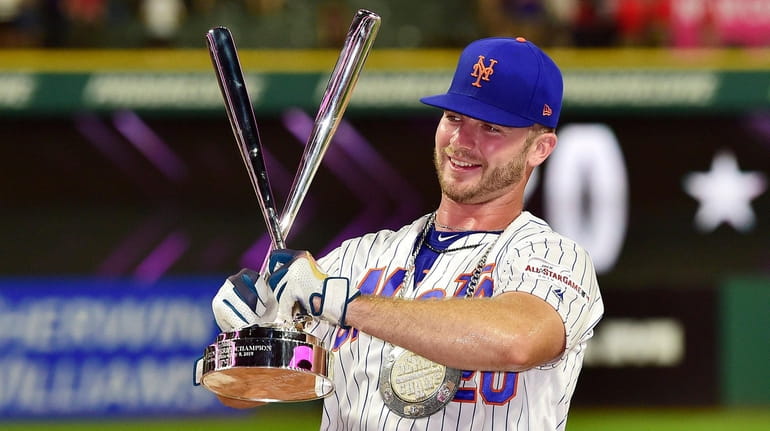 Mets first baseman Pete Alonso poses with the trophy after winning the...