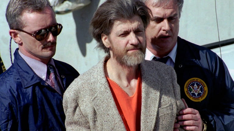 Ted Kaczynski, better known as the Unabomber, is flanked by...