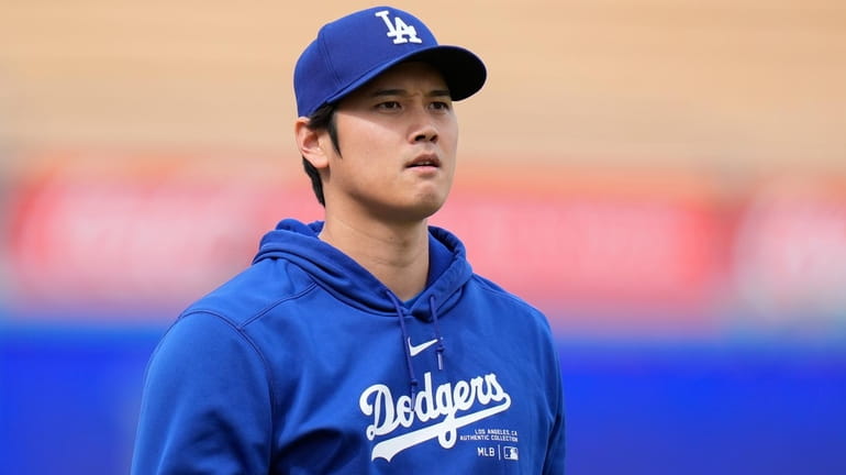 Los Angeles Dodgers' Shohei Ohtani stands on the field during...