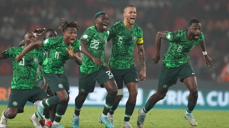 Nigeria's players celebrate winning the penalty shootout during the African...