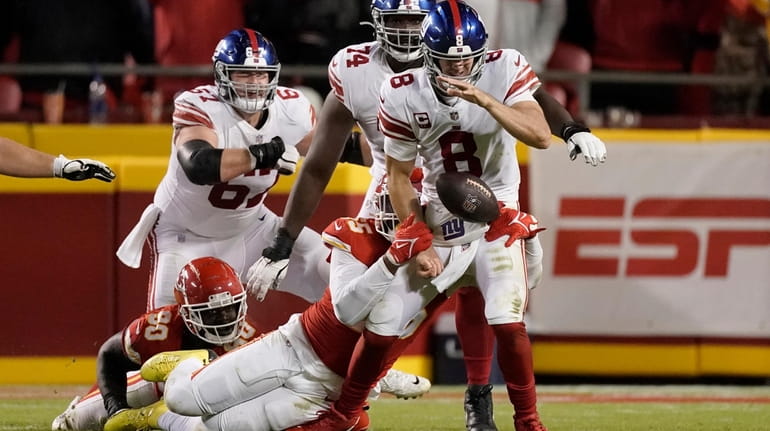Giants quarterback Daniel Jones (8) fumbles as he is sacked...