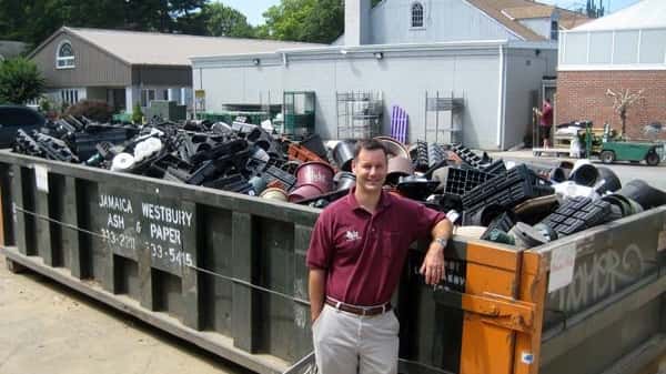 Stephen Hicks show off a dumpster full of pots, flats...