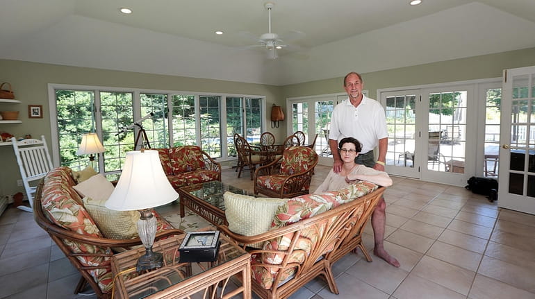 Steve Berner and Kristin Costa in the sunroom of their...