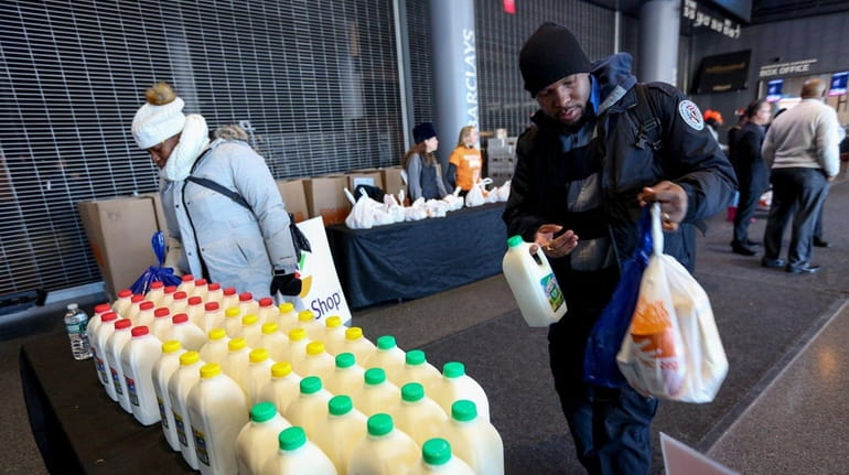 Furloughed federal workers receive food and supplies from the Food...