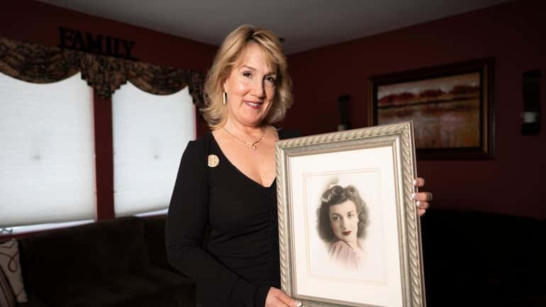 Diane Miller holds a portrait of her mother, Amy Randall,...