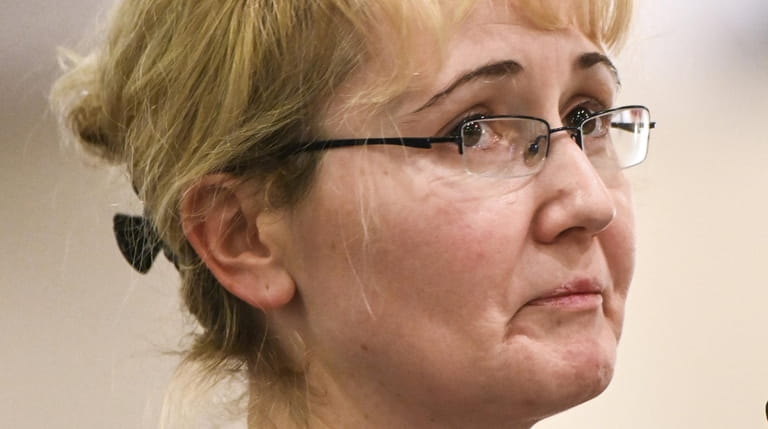 Justyna Zubko-Valva weeps while attending the Nassau County Legislature Health Committee...