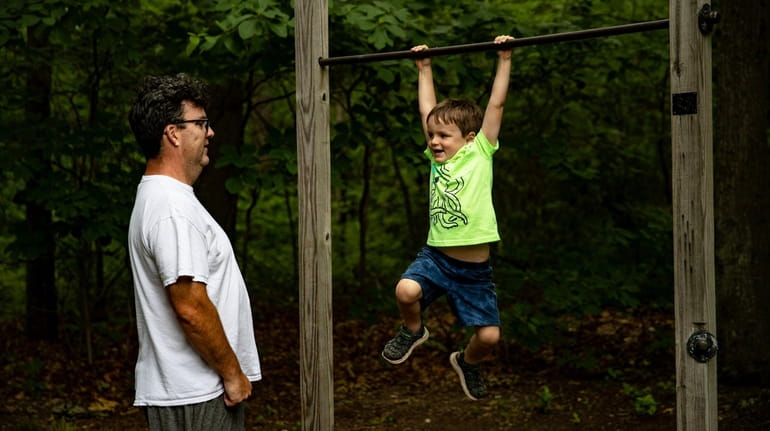 Charles and his son Kevin Masterson, 4, of Nesconset play...