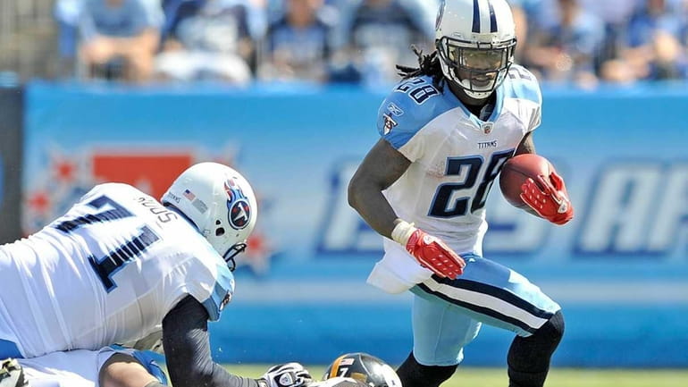 Chris Johnson #28 of the Tennessee Titans runs against the...