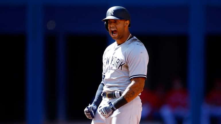 Aaron Hicks #31 of the Yankees celebrates a 3 RBI double...
