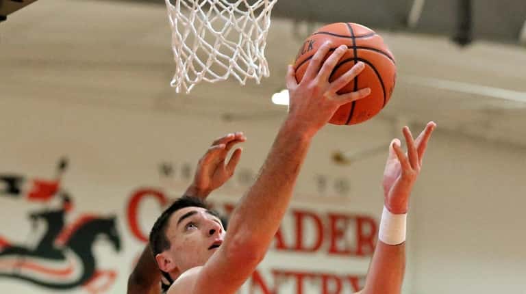 St. Anthony's forward Louis Stallone puts in the reverse layup...