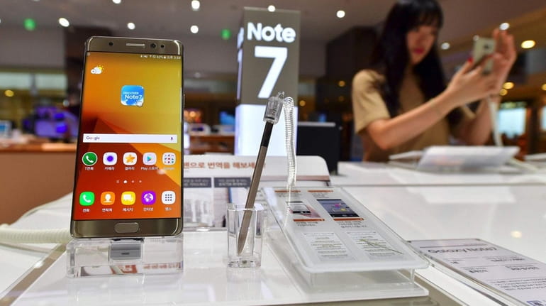 A woman tests a Samsung Galaxy Note7 smartphone at a...