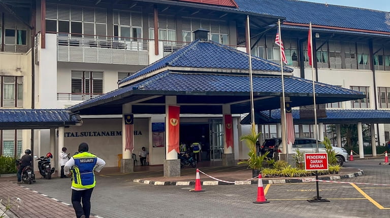 A security officer walks outside the Sultanah Maliha Hospital, where...