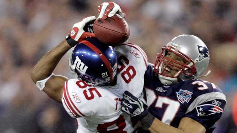 Giants receiver David Tyree catches a 32-yard pass while in...
