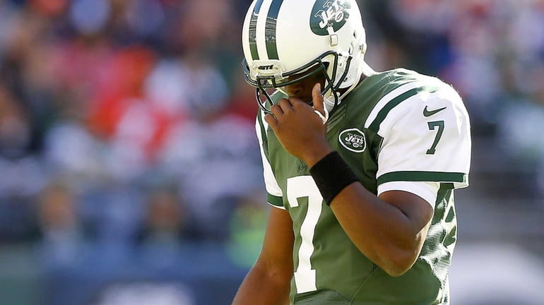 Geno Smith #7 of the Jets walks to the sidelines...