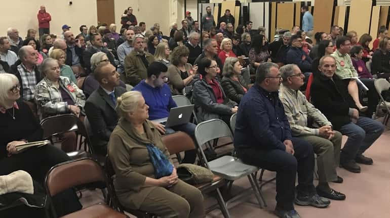 Residents convene at a Patchogue planning board meeting on Tuesday...