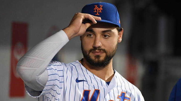 Mets rightfielder Michael Conforto looks on from the dugout before...
