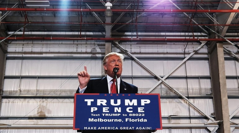 Donald Trump speaks at a Florida airport hanger during a...