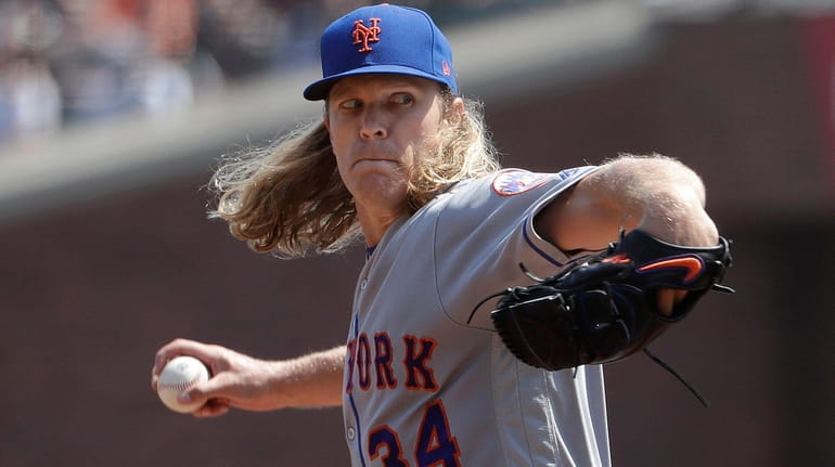 New York Mets pitcher Noah Syndergaard (34) throws against the...