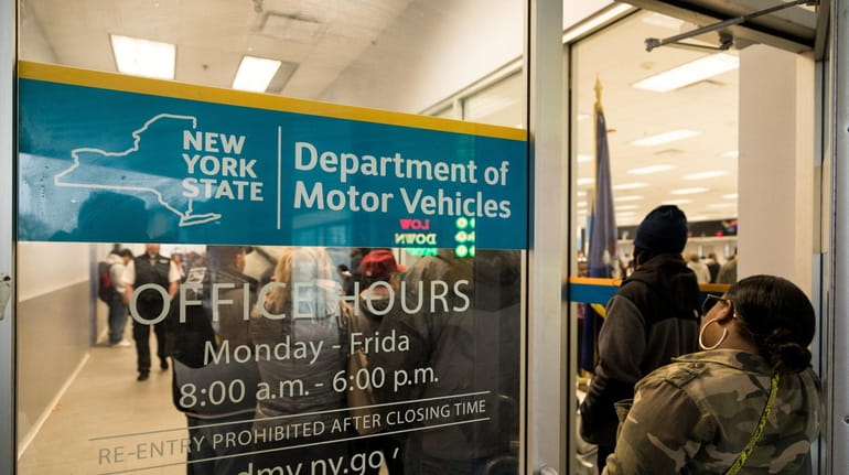 People wait in line at the DMV in Massapequa on...
