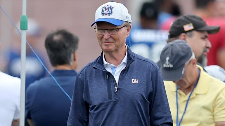 Giants co-owner John Mara watches from the sidelines during training...