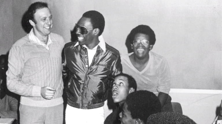 Comedian and movie star Eddie Murphy (in sunglasses) visits teacher his...