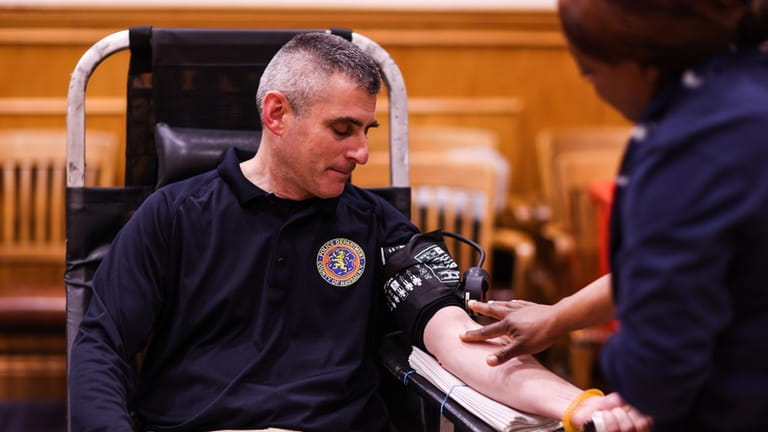 Lt. Robert Connolly gives blood during the New York Blood...