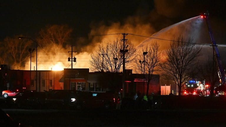 Fire departments fight an industrial fire near 15 Mile Road...