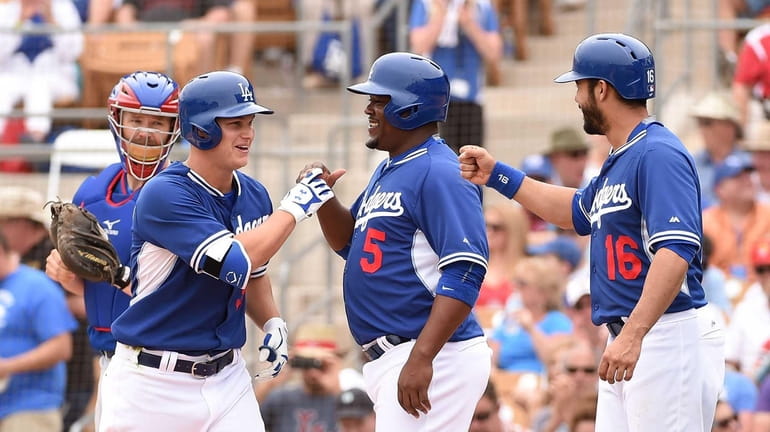 Joc Pederson #31 of the Los Angeles Dodgers and teammates...