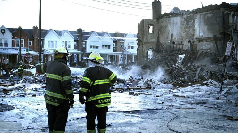 Allentown, Pa., firefighters Thursday investigate the scene of a natural...