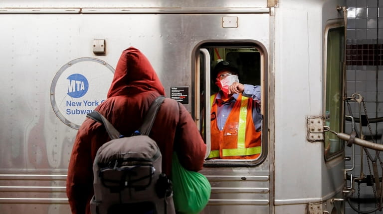 A masked MTA employee in a subway car in April...