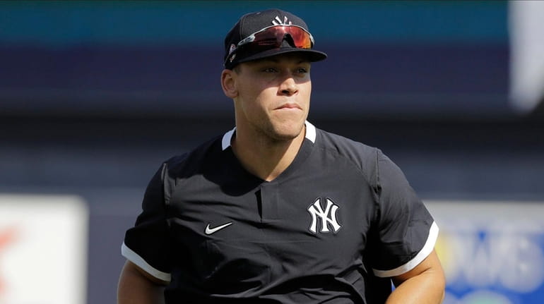 The Yankees' Aaron Judge runs on the field during a...