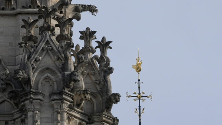 The cross and the rooster atop the Notre Dame de...