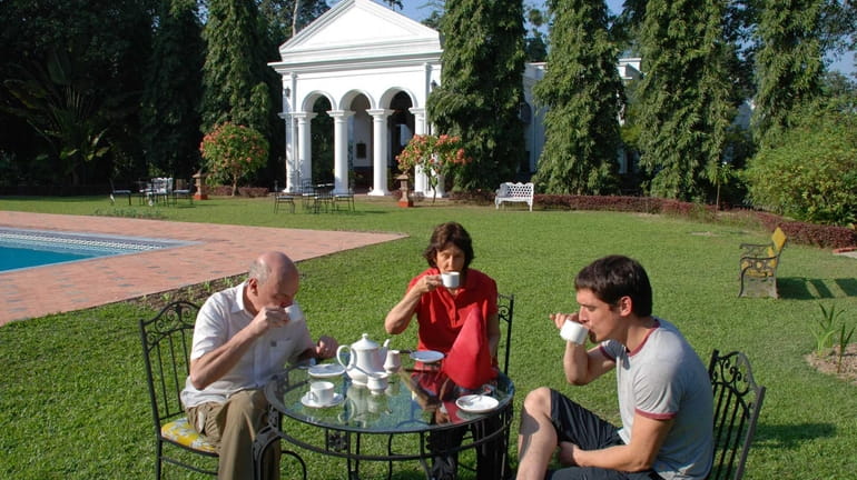 People sip afternoon tea on the lawn of Thengal Manor...