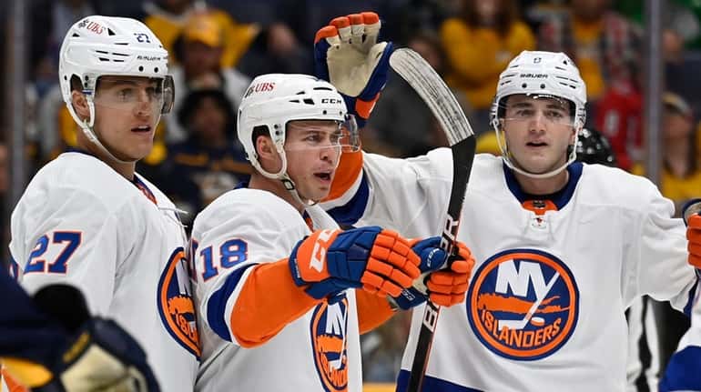 Islanders left wing Anthony Beauvillier celebrates with teammates after scoring...