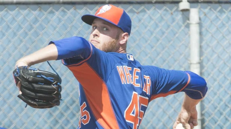 Mets pitcher Zack Wheeler throws a bullpen session during a...