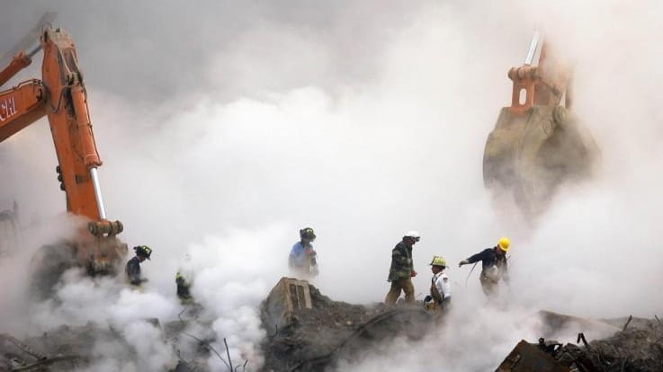Firefighters make their way over the ruins of the World...