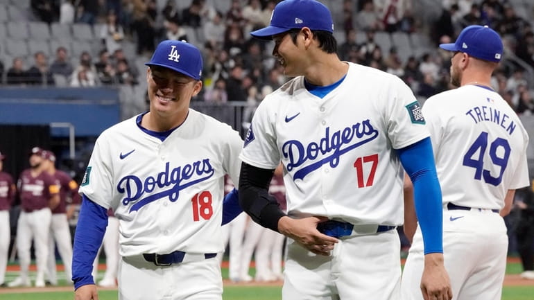 Los Angeles Dodgers' designated hitter Shohei Ohtani , right, and...