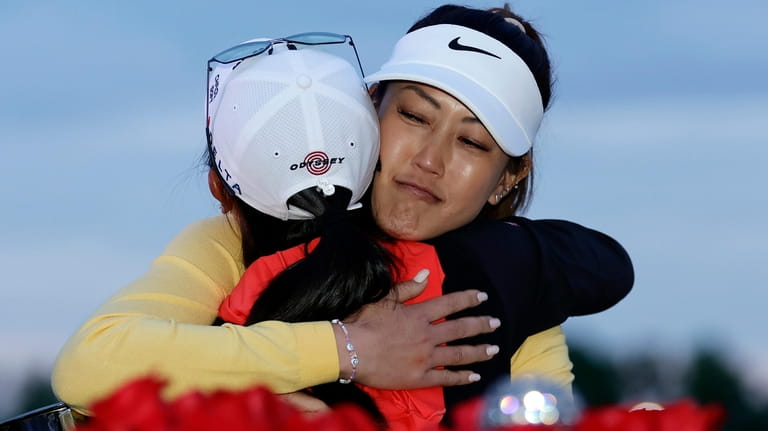 Michelle Wie West, right, hugs Rose Zhang after Zhang won...