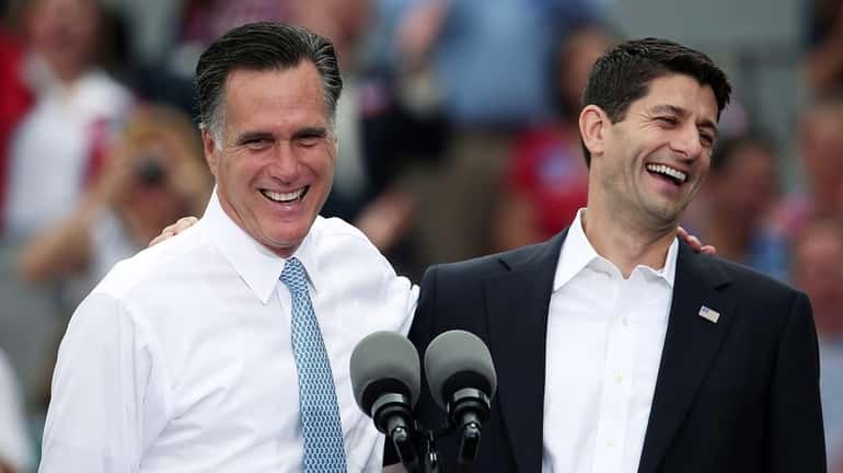 Mitt Romney jokes with Paul Ryan (R-WI) (R) after announcing...