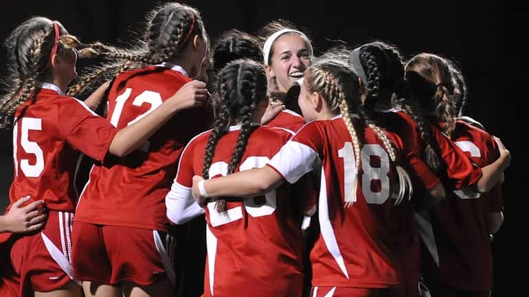 Center Moriches teammates celebrate after defeating Carle Place 3-2 in...