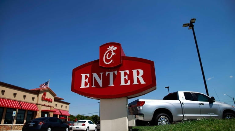 Customers wait in the drive-thru at a Chick-fil-A restaurant in...