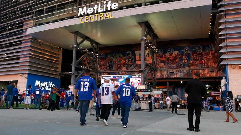 Fans arrive for a game between the New York Giants...