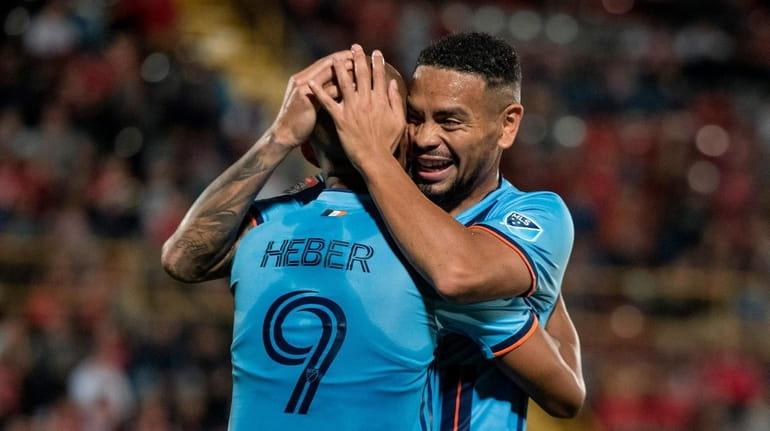 New York City FC's Heber celebrates with Alexander Callens against...