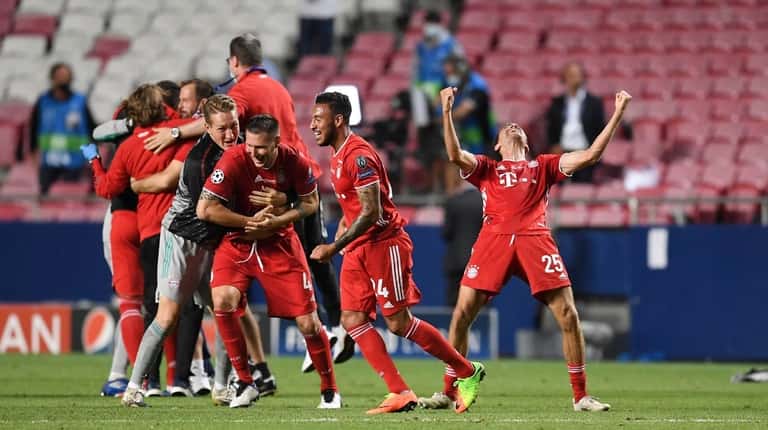 Bayern's Thomas Mueller, right, celebrates after winning the Champions League...
