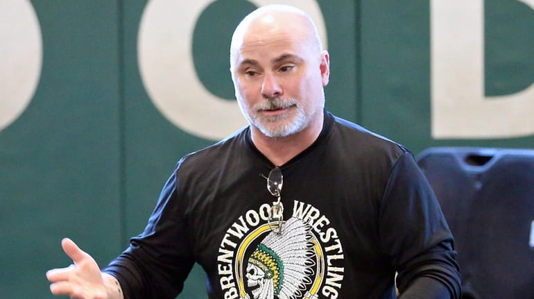 Brentwood wrestling coach Ralph Napolitano talks to his wrestlers during...