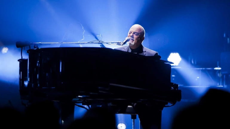 Billy Joel performs with his band at Madison Square Garden,...