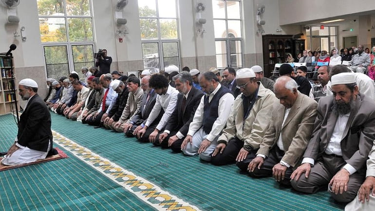 Muslim men pray at afternoon services in the Masjid Darul...