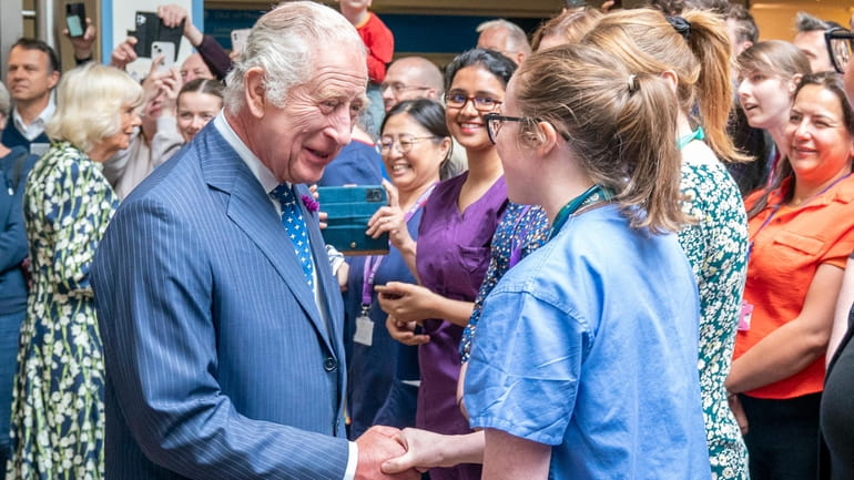 Britain's King Charles III, meets staff and patients at the...