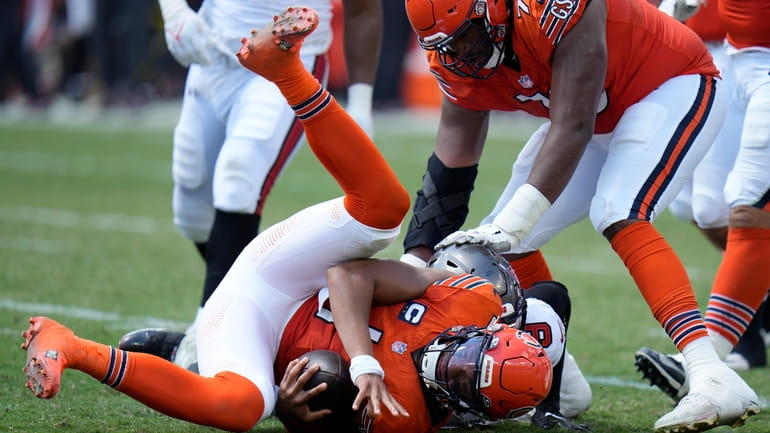 Chicago Bears quarterback Justin Fields (1) is sacked by Tampa...